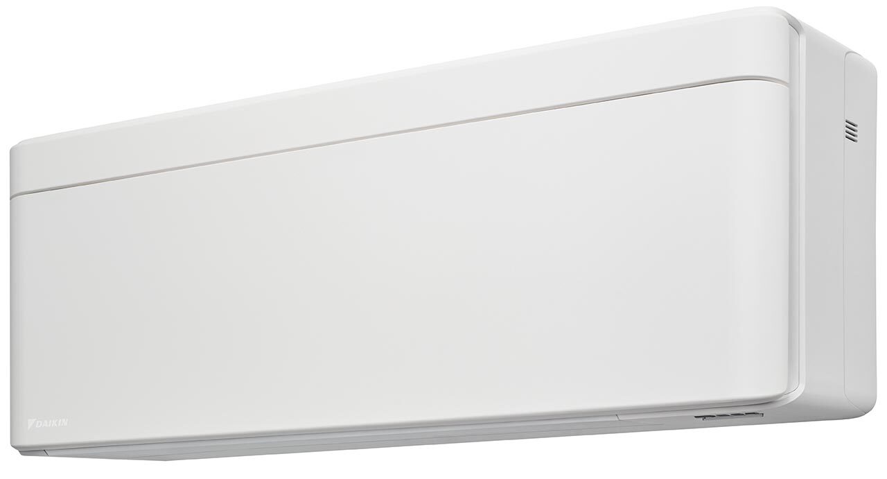 A white indoor unit with multiple vents is mounted on a wall against a dark background, showcasing its sleek design